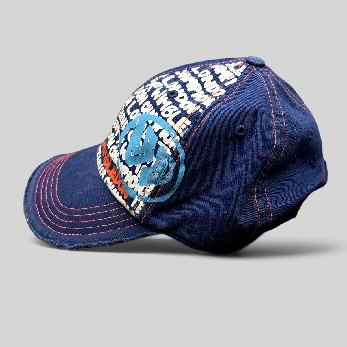Raree Finds navy and orange distressed strapback hat with Wimbledon graphic print and frayed edges, side view.