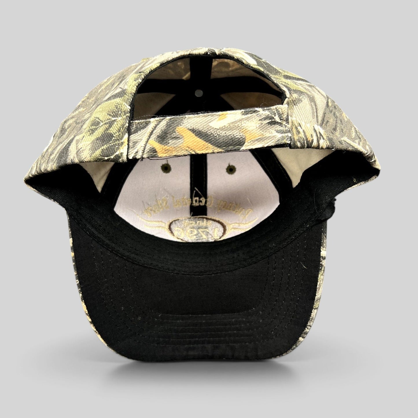 Raree Finds Putney General Store woodland camo strapback hat with black brim and interior logo detail
