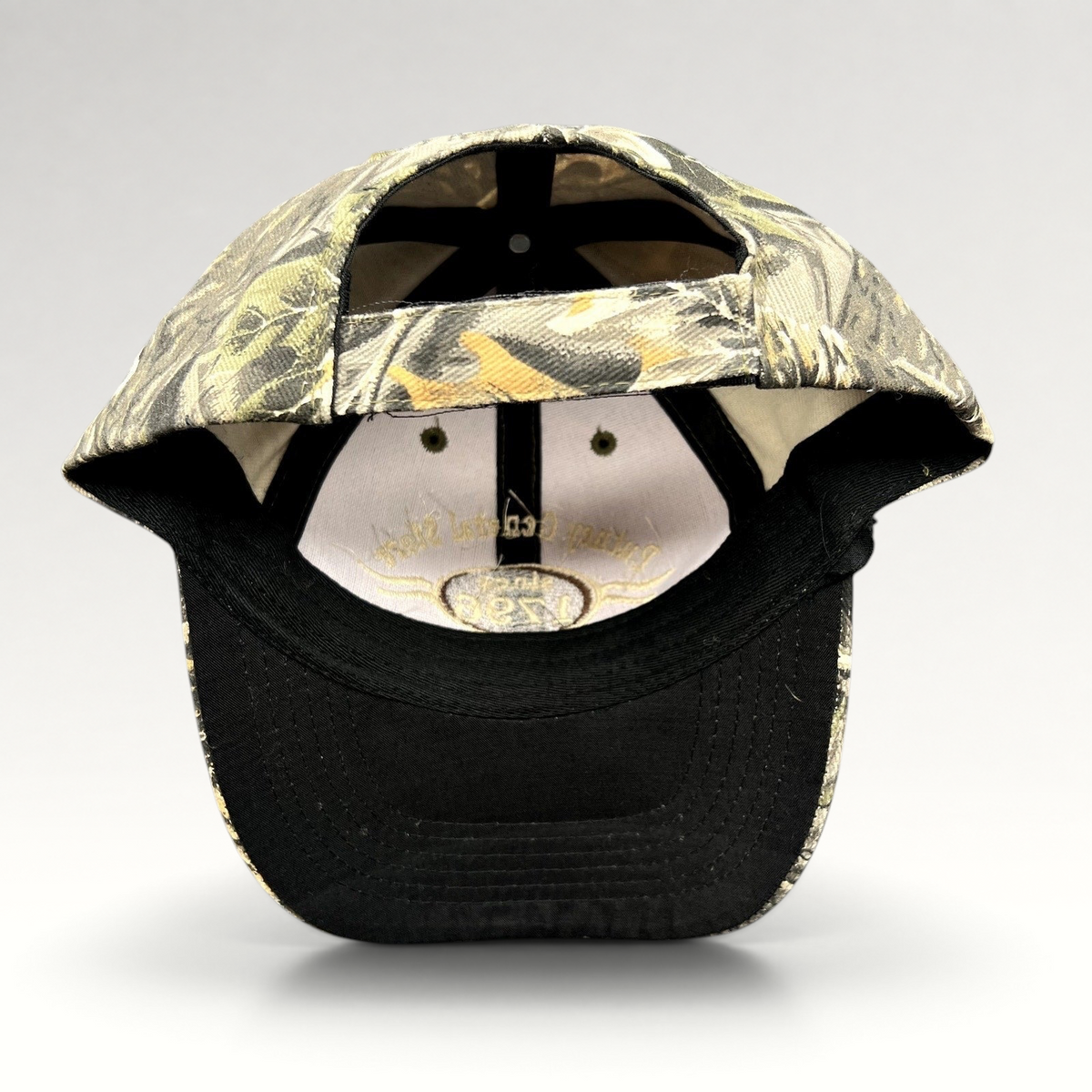 Raree Finds Putney General Store woodland camo strapback hat with black brim and interior logo detail