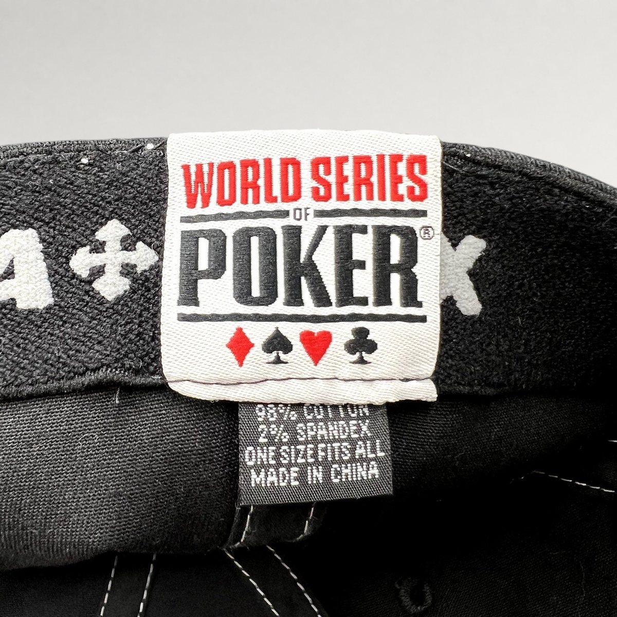 Raree Finds 2010 World Series of Poker hat interior tag showing brand logo, card suits, and material composition