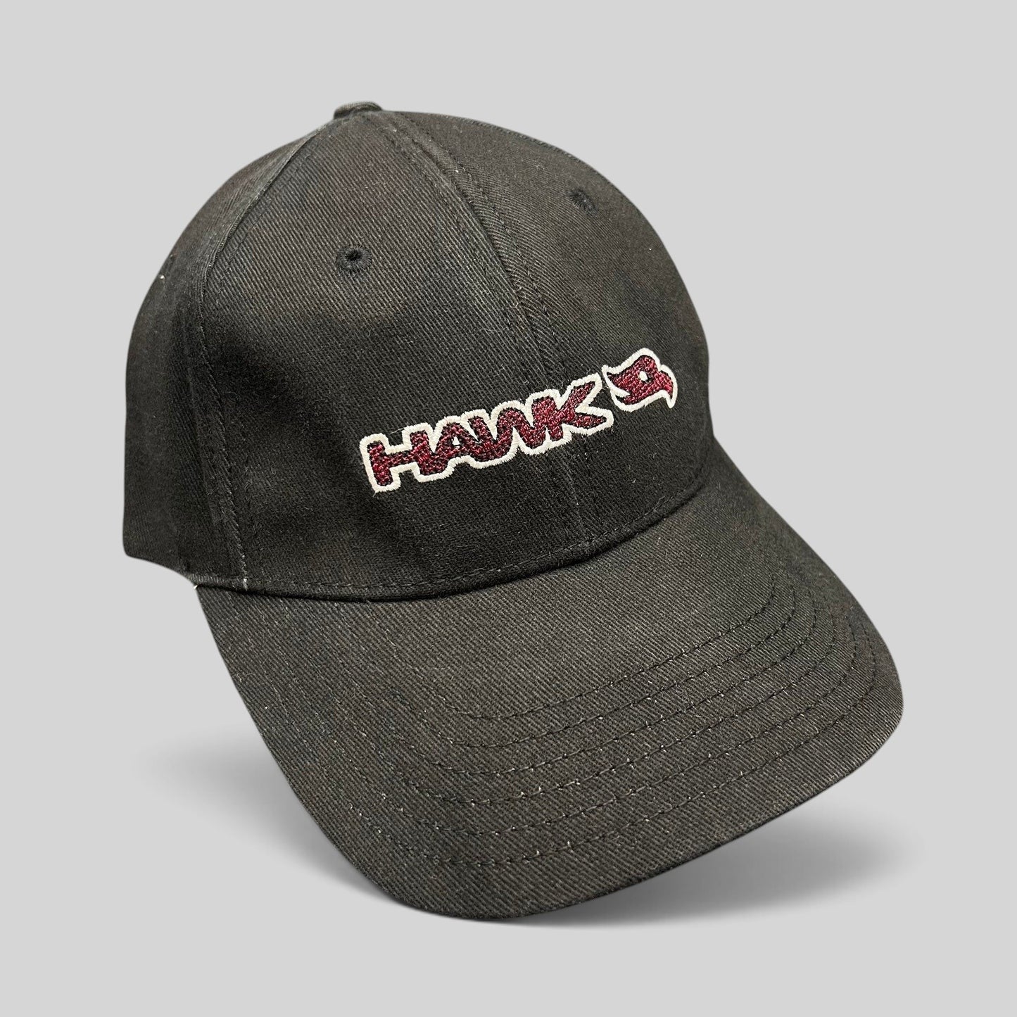 Raree Finds youth fitted black skate hat featuring an embroidered HAWK wordmark and bird logo in red and white.
