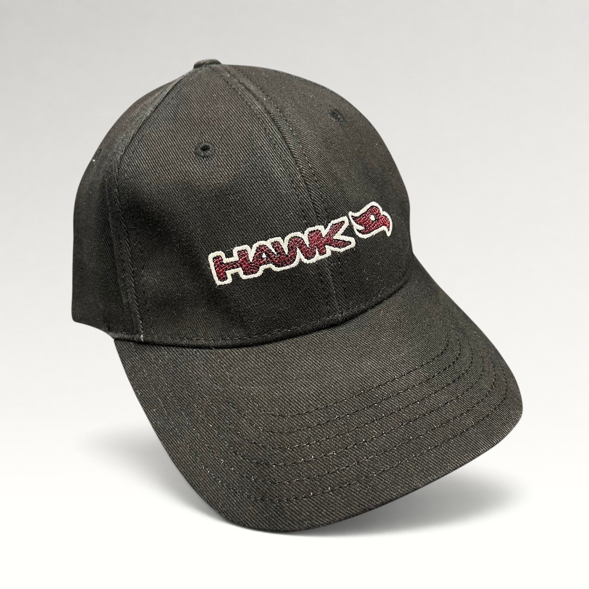 Raree Finds youth fitted black skate hat featuring an embroidered HAWK wordmark and bird logo in red and white.