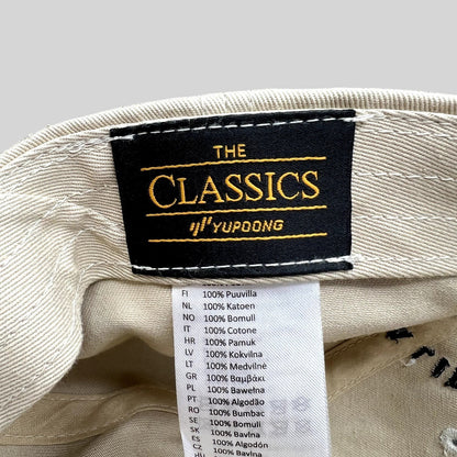 Raree Finds Monopoly GO strapback hat interior showing The Classics Yupoong brand label and 100% cotton care tag