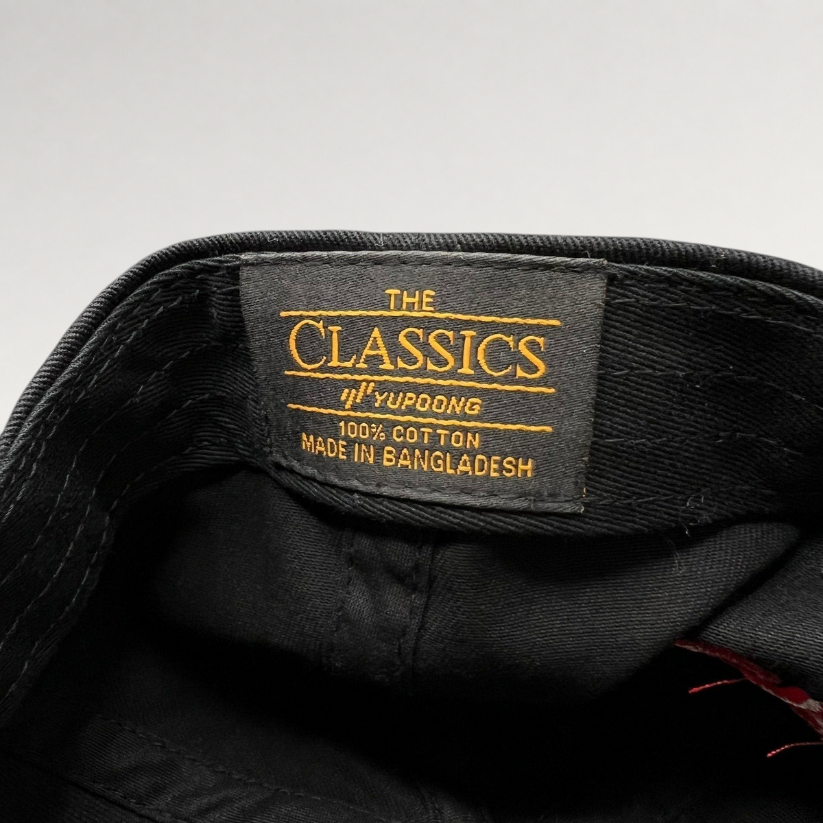 Raree Finds Yupoong The Classics black cotton hat interior tag with brand and material details
