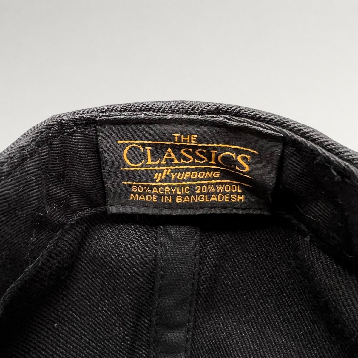 Raree Finds Yupoong The Classics black wool-blend snapback hat interior label showing material composition