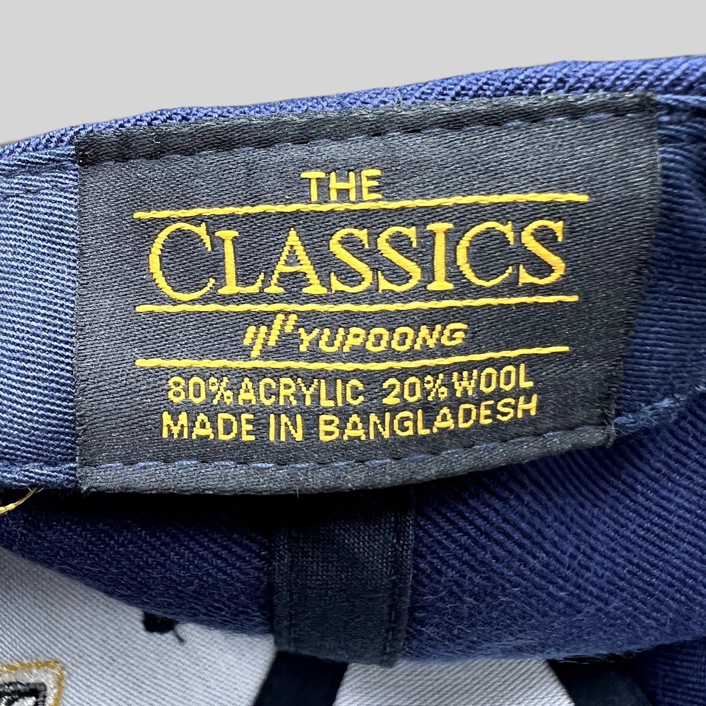 Raree Finds vintage Yupoong The Classics hat label showing 80 percent acrylic and 20 percent wool material composition
