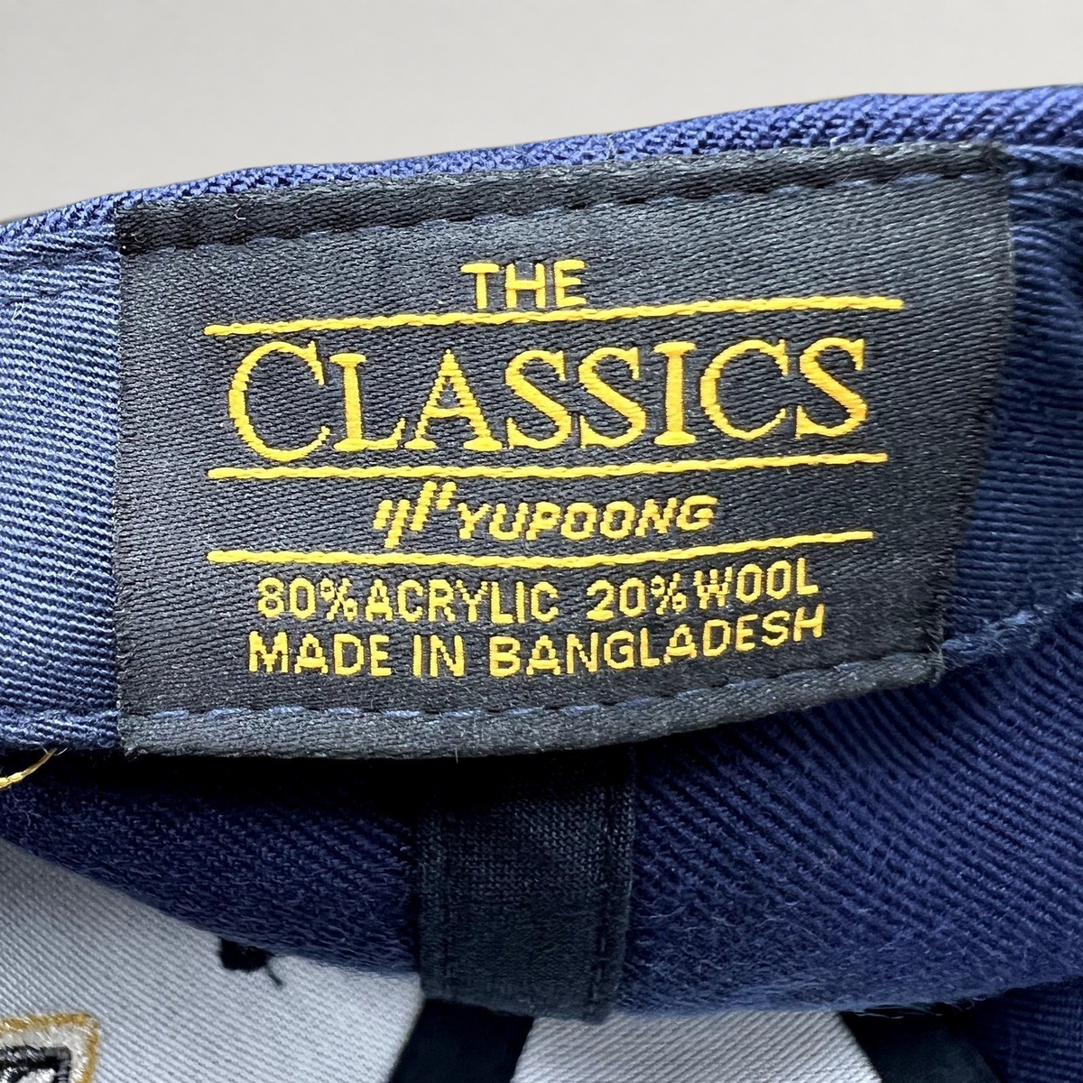 Raree Finds vintage Yupoong The Classics hat label showing 80 percent acrylic and 20 percent wool material composition