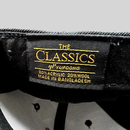 Raree Finds Yupoong The Classics black snapback hat interior label showing material composition and origin