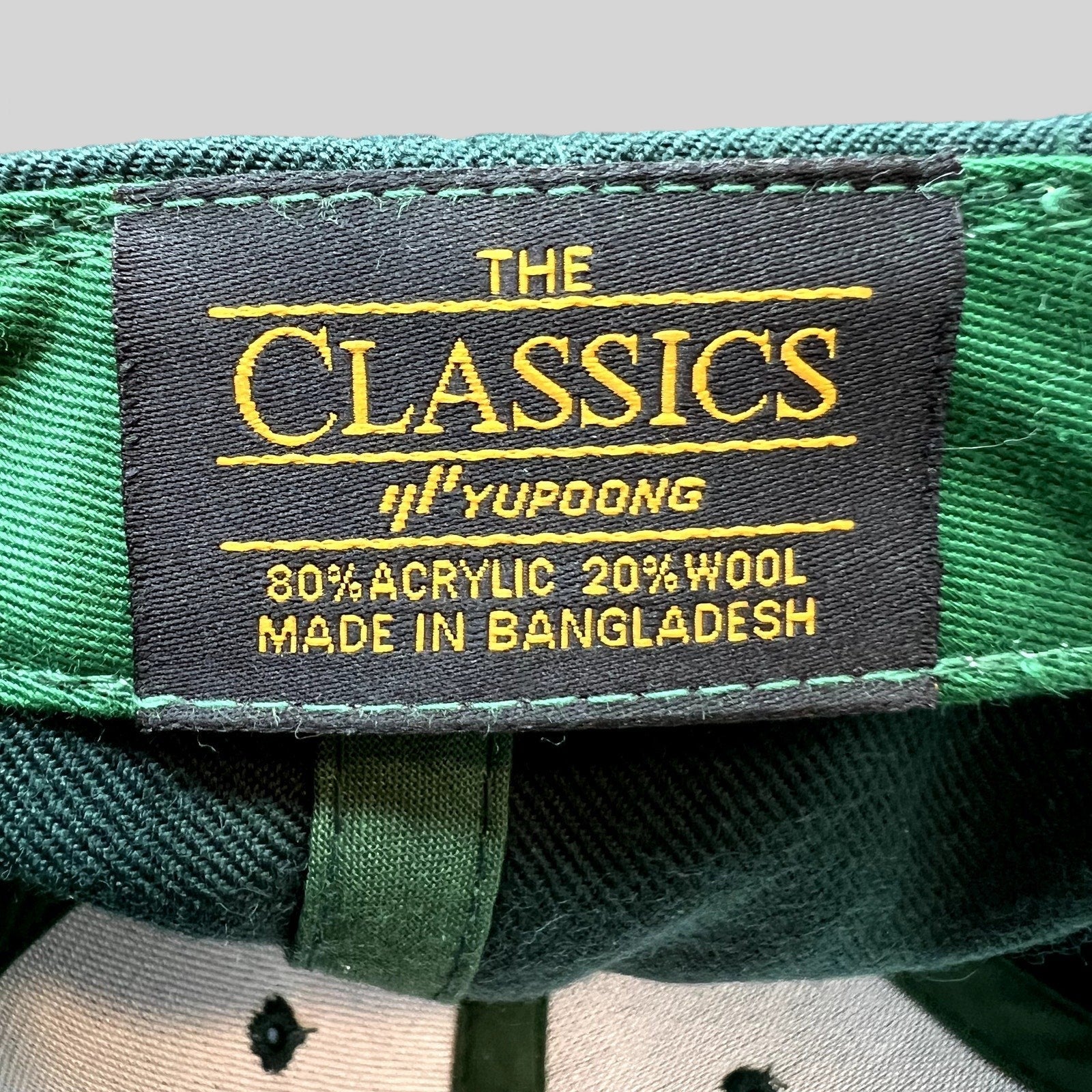 Raree Finds Penny Pound Ice snapback hat interior label showing Yupoong Classics branding on dark green fabric