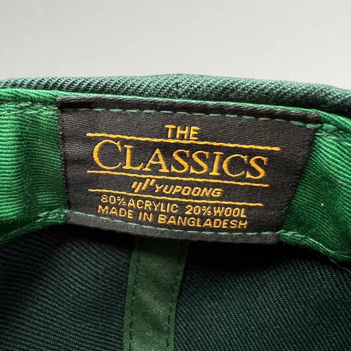Raree Finds vintage Yupoong Classics snapback hat interior label showing material composition and origin
