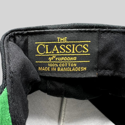 Raree Finds USC Trojans snapback interior label showing The Classics Yupoong branding and 100% cotton material tag