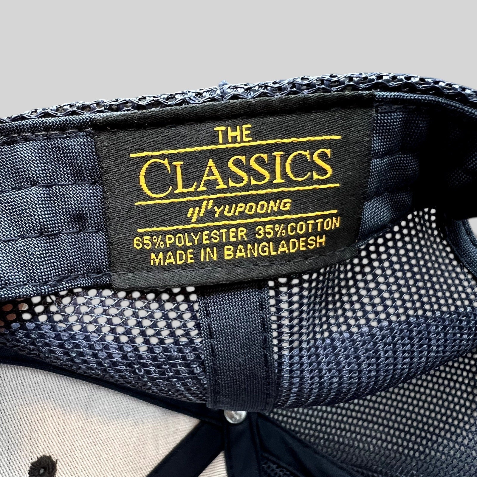 Raree Finds Diller Teen Fellows Yupoong Classics trucker hat interior label showing material and origin details