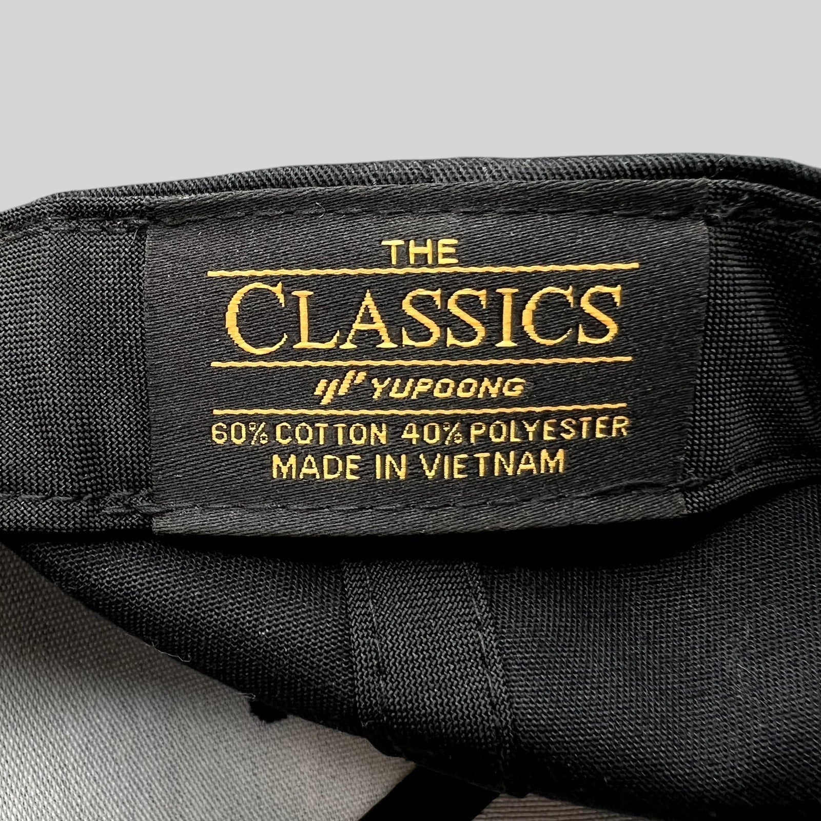 Raree Finds Yupoong Classics snapback hat interior label showing material composition and manufacturing origin