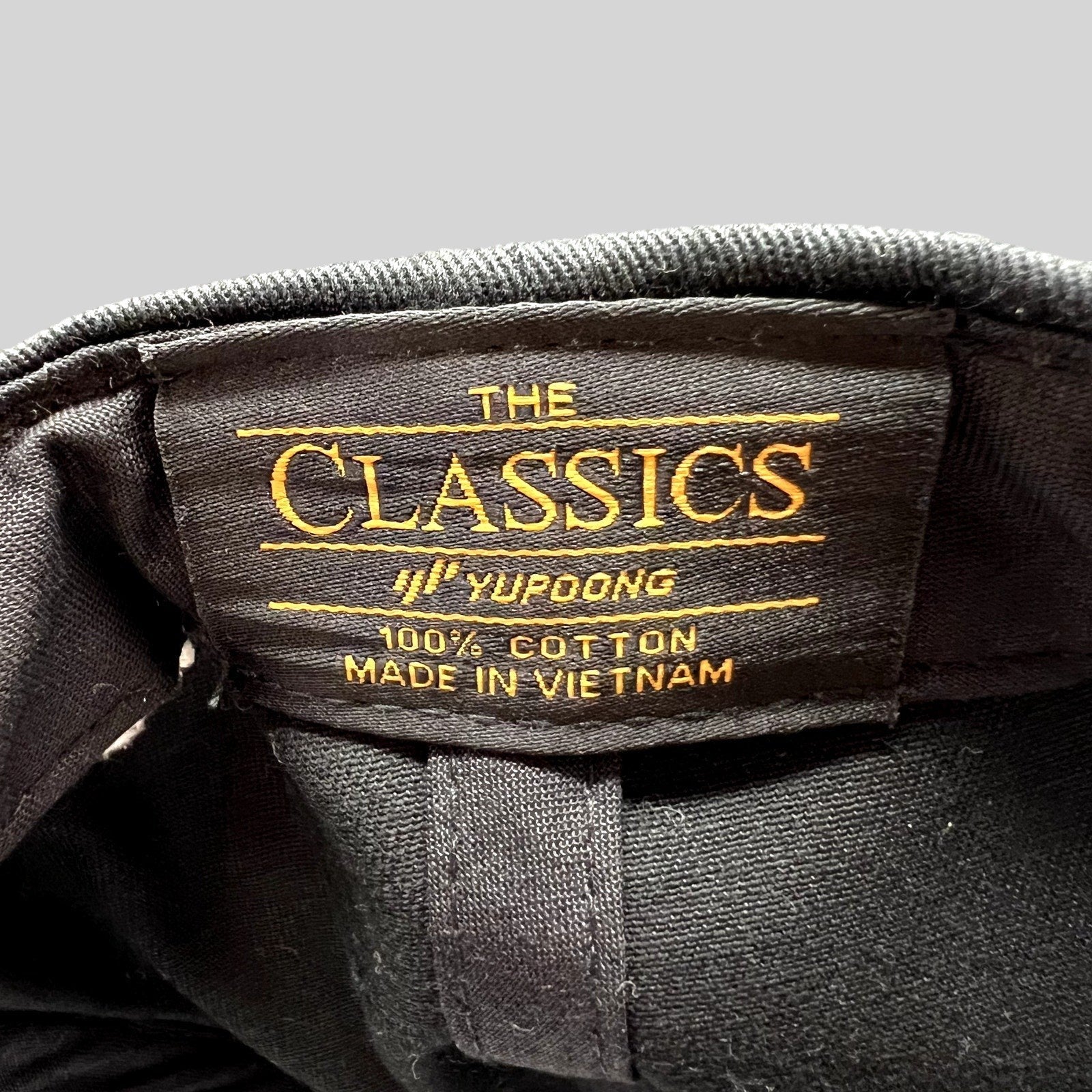Raree Finds Yupoong Classics black cotton snapback hat interior label with gold embroidery