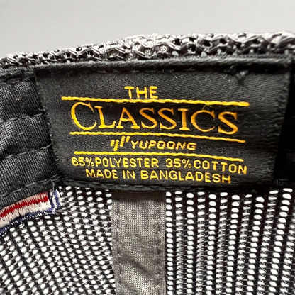 Raree Finds Yupoong Classics interior hat label showing material composition and brand logo on black fabric