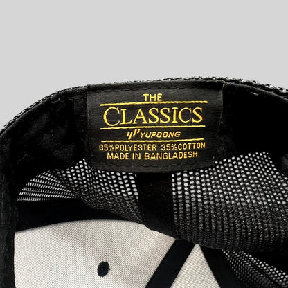 Raree Finds Yupoong Classics trucker hat interior label showing material composition and branding