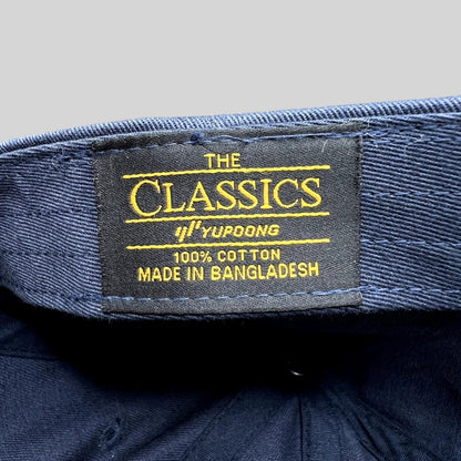 Raree Finds navy blue cotton dad hat interior label showing The Classics Yupoong branding and origin details