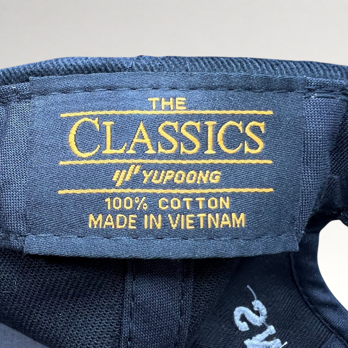 Raree Finds black Yupoong The Classics 100 percent cotton hat interior label with gold embroidery