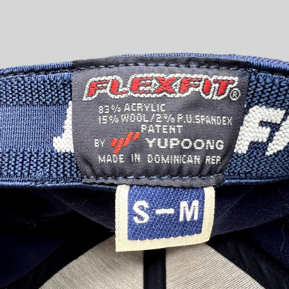 Raree Finds Yupoong Flexfit hat interior label showing size S/M and material composition on a navy blue cap
