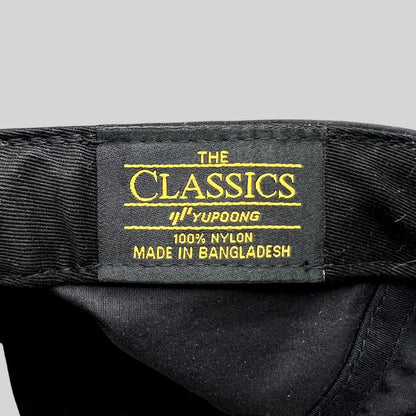 Raree Finds Yupoong Classics black nylon hat interior label with gold text detailing material and origin