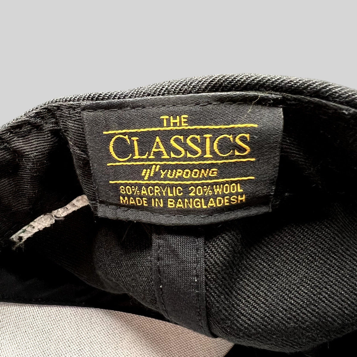 Raree Finds Yupoong The Classics snapback hat interior label showing material composition and origin