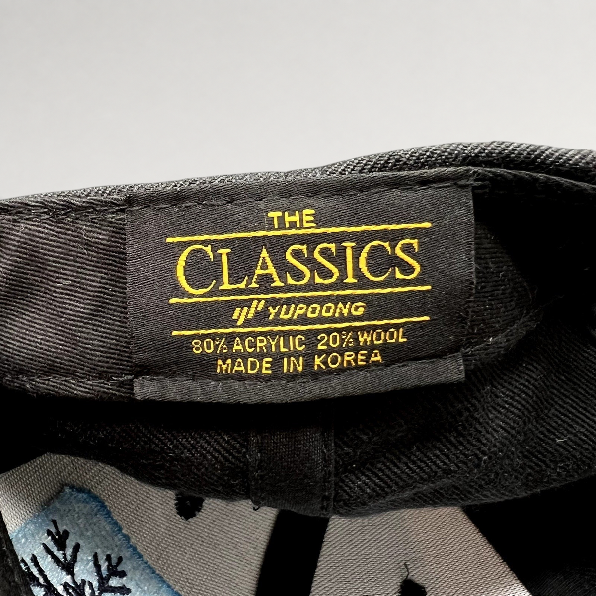 Raree Finds vintage Yupoong The Classics snapback hat interior label showing material and origin details
