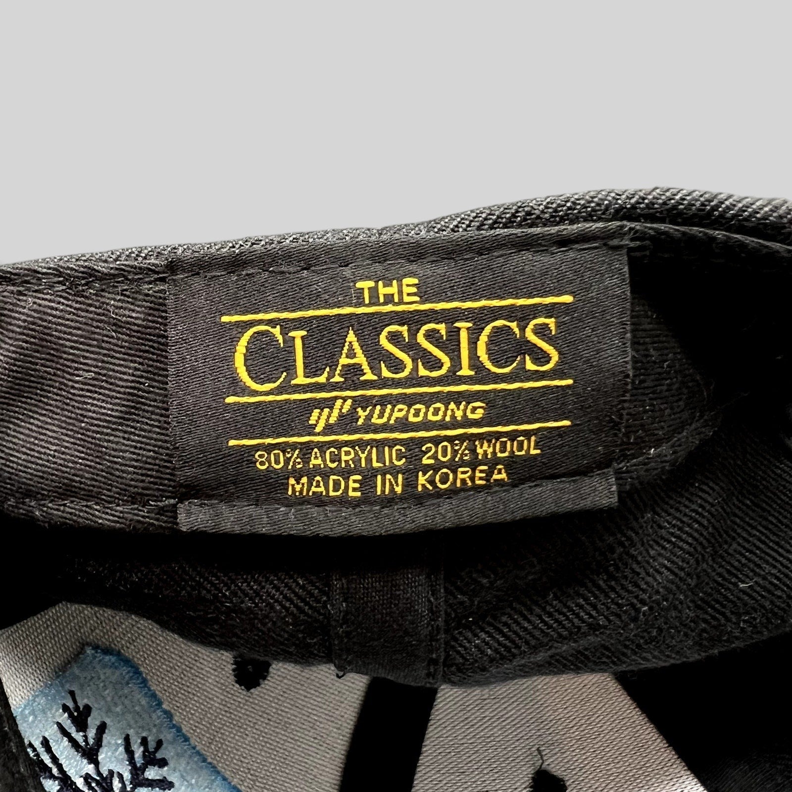Raree Finds vintage Yupoong The Classics snapback hat interior tag showing material blend and made in Korea label