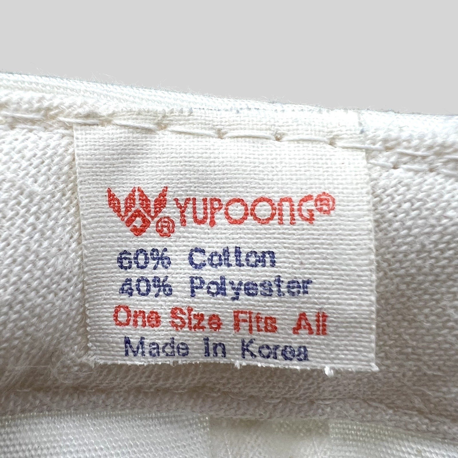 Raree Finds vintage Yupoong hat interior tag showing 60 percent cotton and 40 percent polyester blend made in Korea