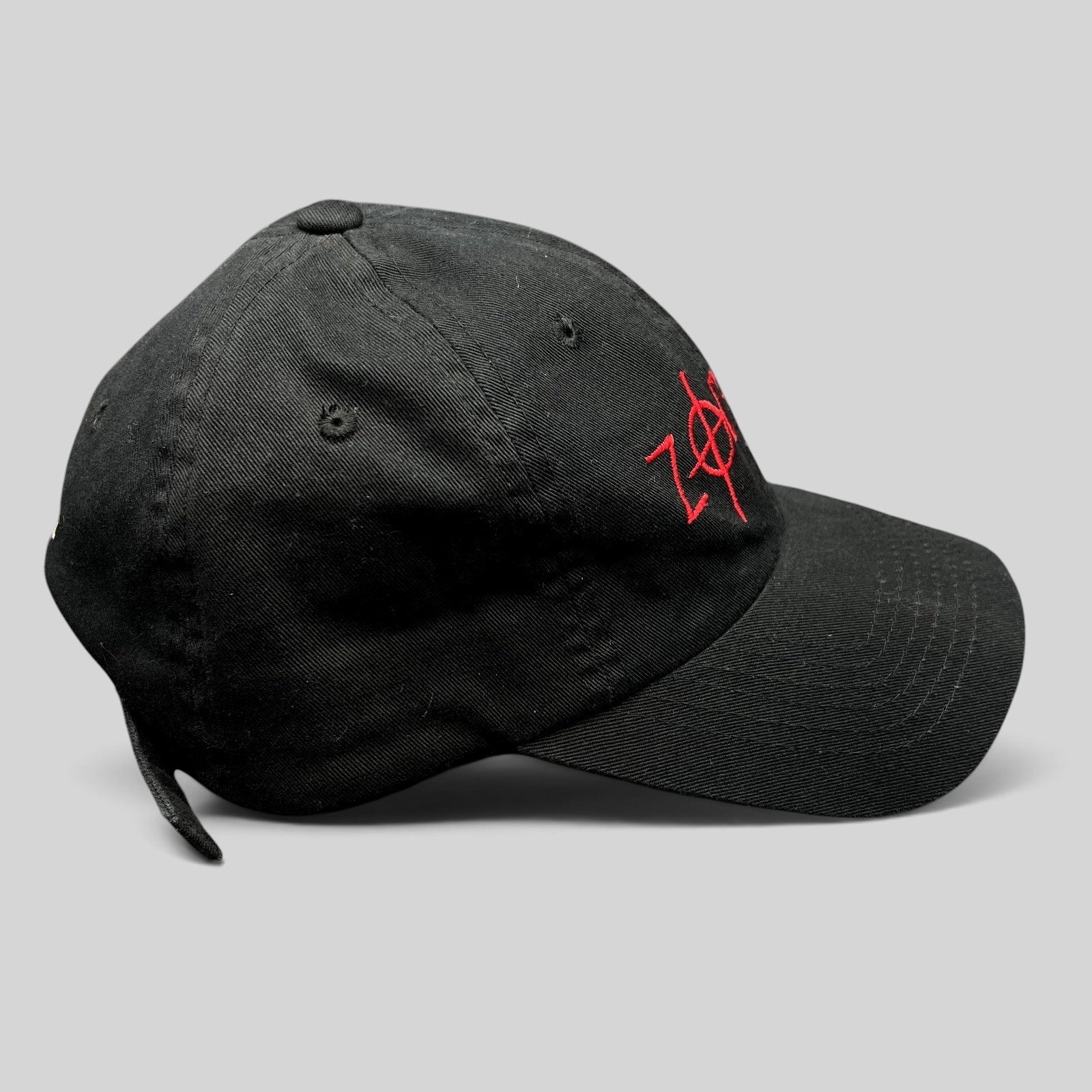 Raree Finds black cotton strapback hat with red embroidered Zodiac movie logo and curved brim, side profile view.