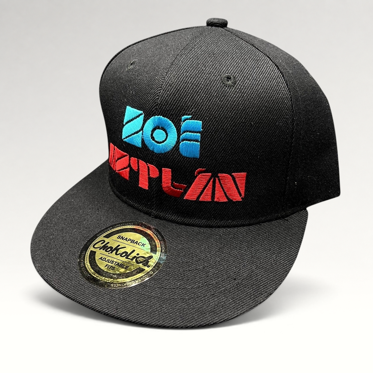 Raree Finds black Chokolids snapback hat featuring embroidered turquoise and red Zoe Aztlan album graphics on front
