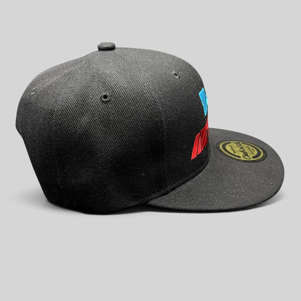 Raree Finds black Chokolids snapback hat featuring embroidered Zoe Aztlan album graphics in turquoise and red