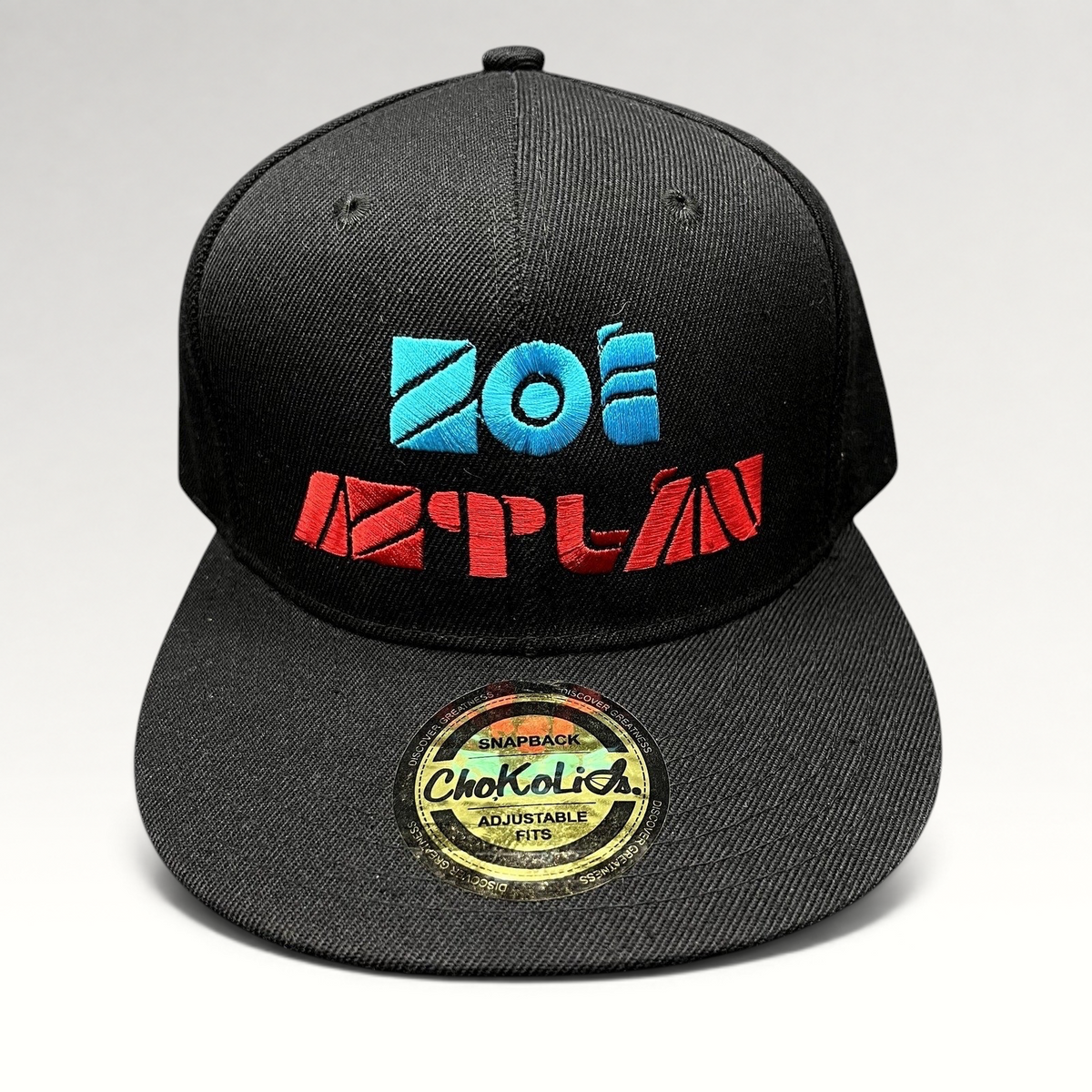 Raree Finds black Chokolids snapback hat featuring embroidered turquoise and red Zoe Aztlan album logo on front