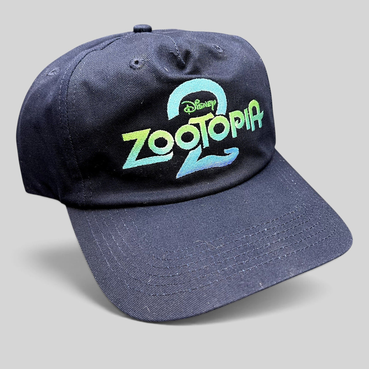 Raree Finds Disney Zootopia 2 promotional navy blue strapback hat with vibrant embroidered logo on the front crown.