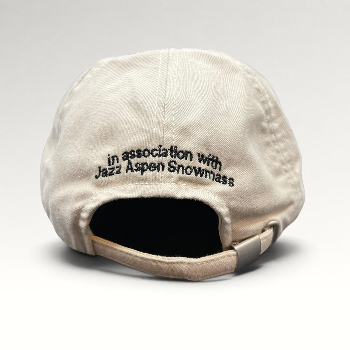 Rear embroidery reading In association with Jazz Aspen Snowmass and adjustable strap
